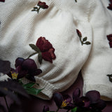 close up of the hellebores romper for babies in white