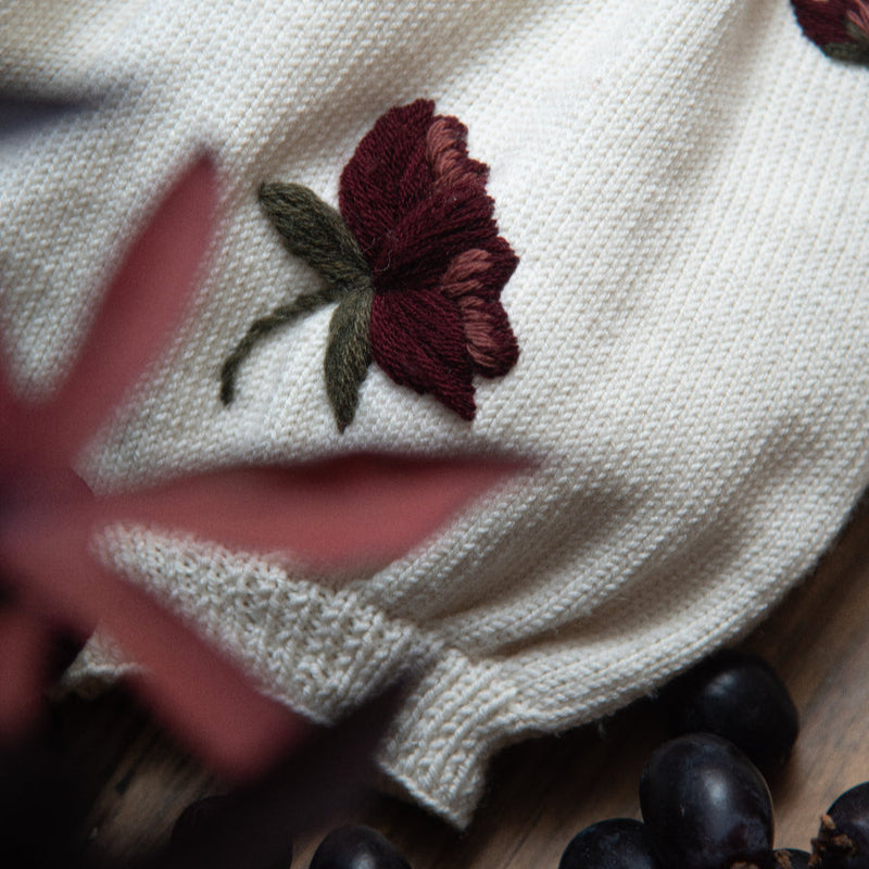 close up of the hellebores romper in white