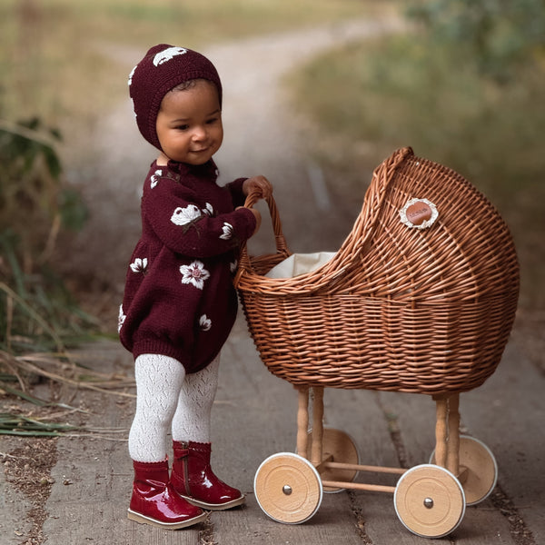 child in knitted hellebores romper