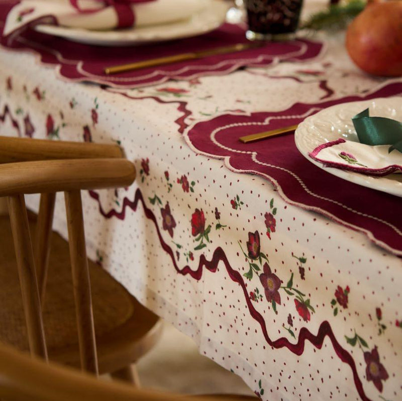 Hellebores Christmas tablecloth draped over a dining table, showcasing its elegant design and festive charm in a holiday setting.