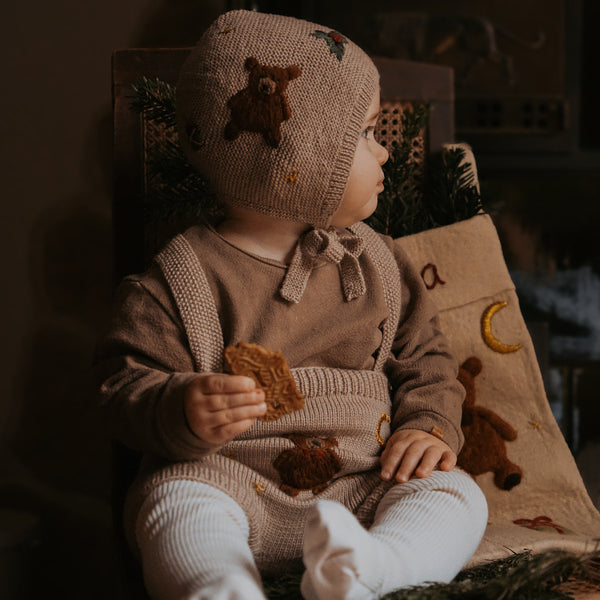 knitted teddy bonnet on a little baby boy