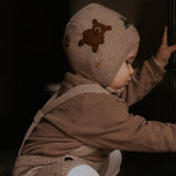 knitted teddy bonnet on a little baby boy