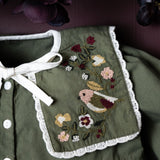 close up of embroidered collar with flowers and bird