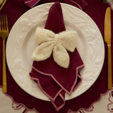 Little Bow Ornament in Cream White color used as a napkin ring, adding a soft and romantic touch to holiday table settings.