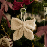 Little Bow Ornament in Cream White color displayed on a Christmas tree, showcasing its elegant and traditional look as part of holiday decorations.