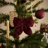 Little Bow Ornament in Grape color displayed on a Christmas tree, adding a soft and romantic touch with traditional festive appeal.