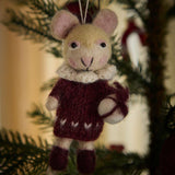 Christmas tree decorated with a handcrafted grape-colored mouse ornament, adding a touch of homemade elegance to the festive display.