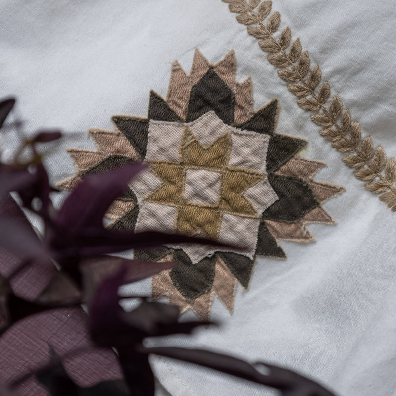 close up of white patchwork dress