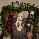 Collection of Personalized Garland Stockings in various colors, with custom name embroidery and festive Christmas designs.