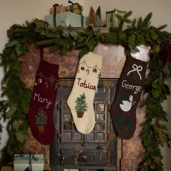 Collection of Personalized Goose Stockings in various colors, including Nutty Brown, with hand-embroidered Christmas goose and custom names.