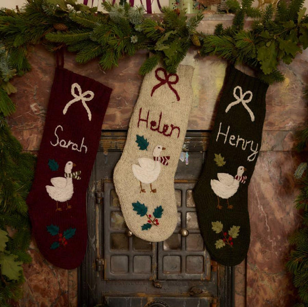 Collection of Personalized Goose Stockings in various colors, with hand-embroidered Christmas goose and custom names.