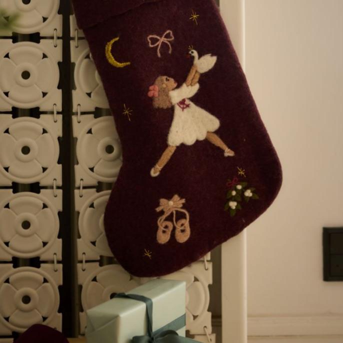 Dark grape holiday stocking with embroidered Odette displayed hanging in a festive setting, adding a touch of elegance to holiday decorations.