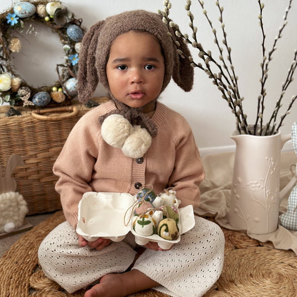 A child holding this product, surrounded by decorative accents in the room.







