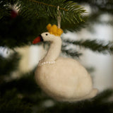 Hand-felted white swan ornament hanging on a Christmas tree, adding a touch of sophistication and elegance to the holiday decor.