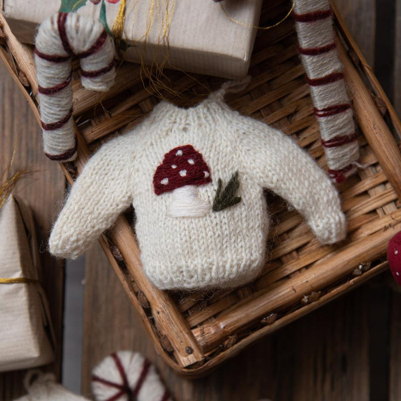 sweater ornament knitted from wool with embroidered mushroom