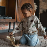 little boy wearing knitted and embroidered bugs life cardigan for children