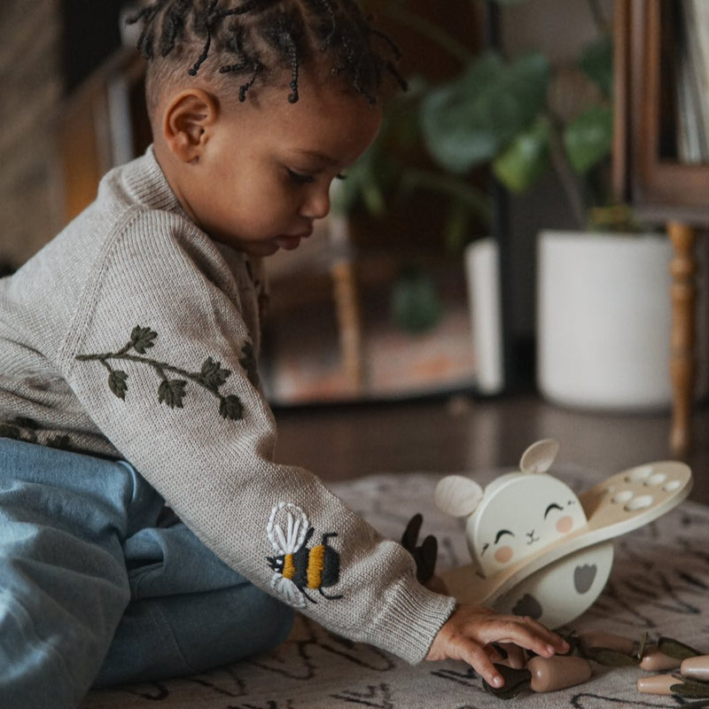 little boy wearing knitted and embroidered bugs life cardigan for children