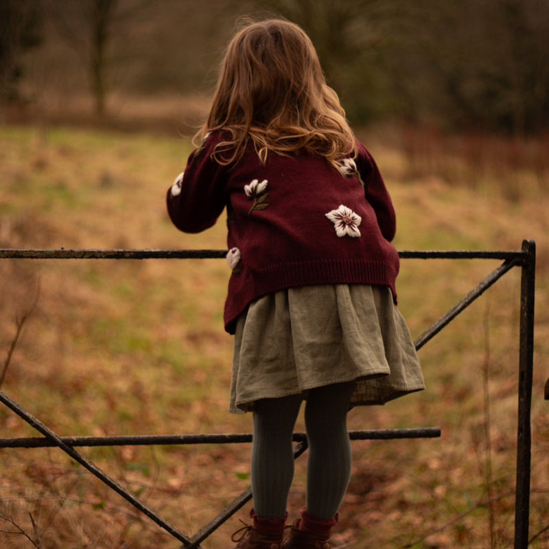 little girl wearing hellebores cardigan in grape