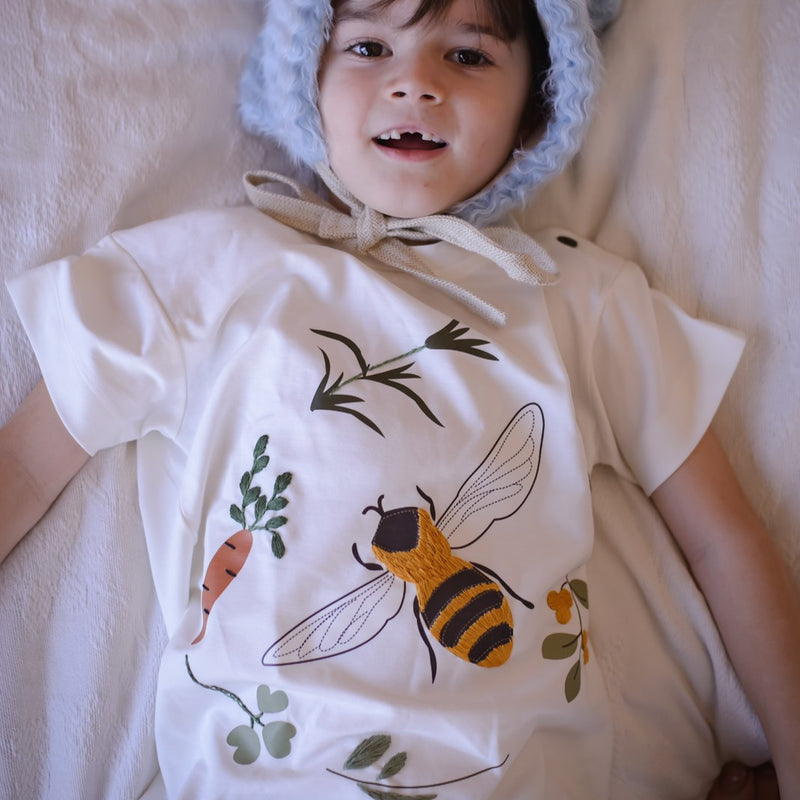 a boy wearing embroidered bee shirt