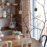 felted easter eggs hanging on a branch