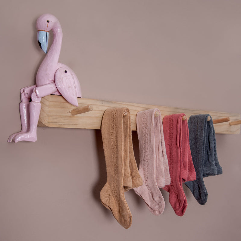 different coloured rib tights in hole pattern hanged in coat  rack