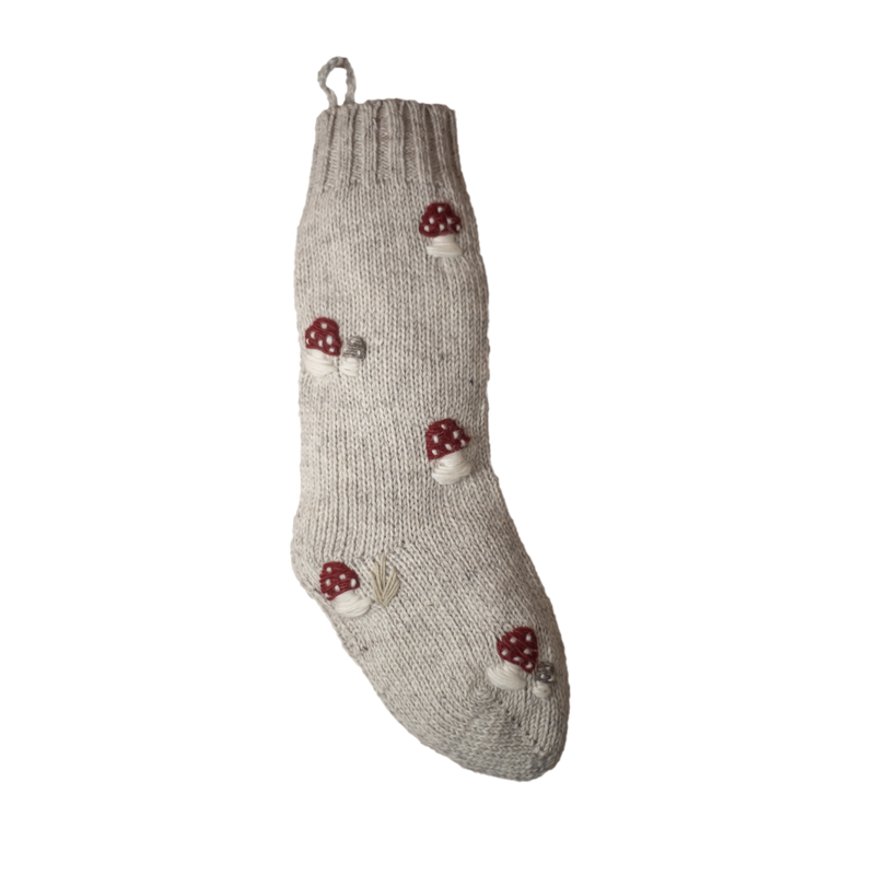 Rye-colored knitted woolen Christmas stocking featuring a hand-embroidered mushroom pattern for a unique festive touch.