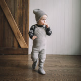 baby boy wearing hand knitted jumpsuit light grey