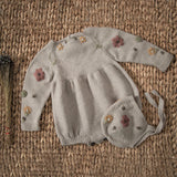 hand knitted and embroidered romper and bonnet for baby in nude colour