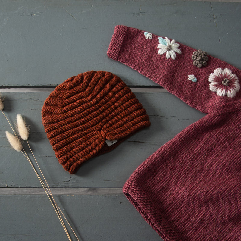  hand knitted hat in our dreamy soft merino wool with hand knitted sweater which has floral embroidery on it