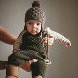 baby boy wearing hand knitted jumpsuit moss