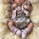 sweet baby girl wearing our cozy flora footies dust pink