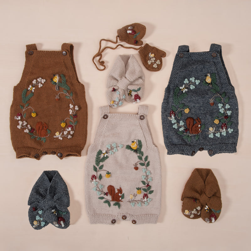 flat lay picture of woodland romper oats along with other woodland range outfits