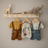 woodland suspender shorts caramel with hemp cotton t-short masala hanged in coat rack along with other woodland range outfits